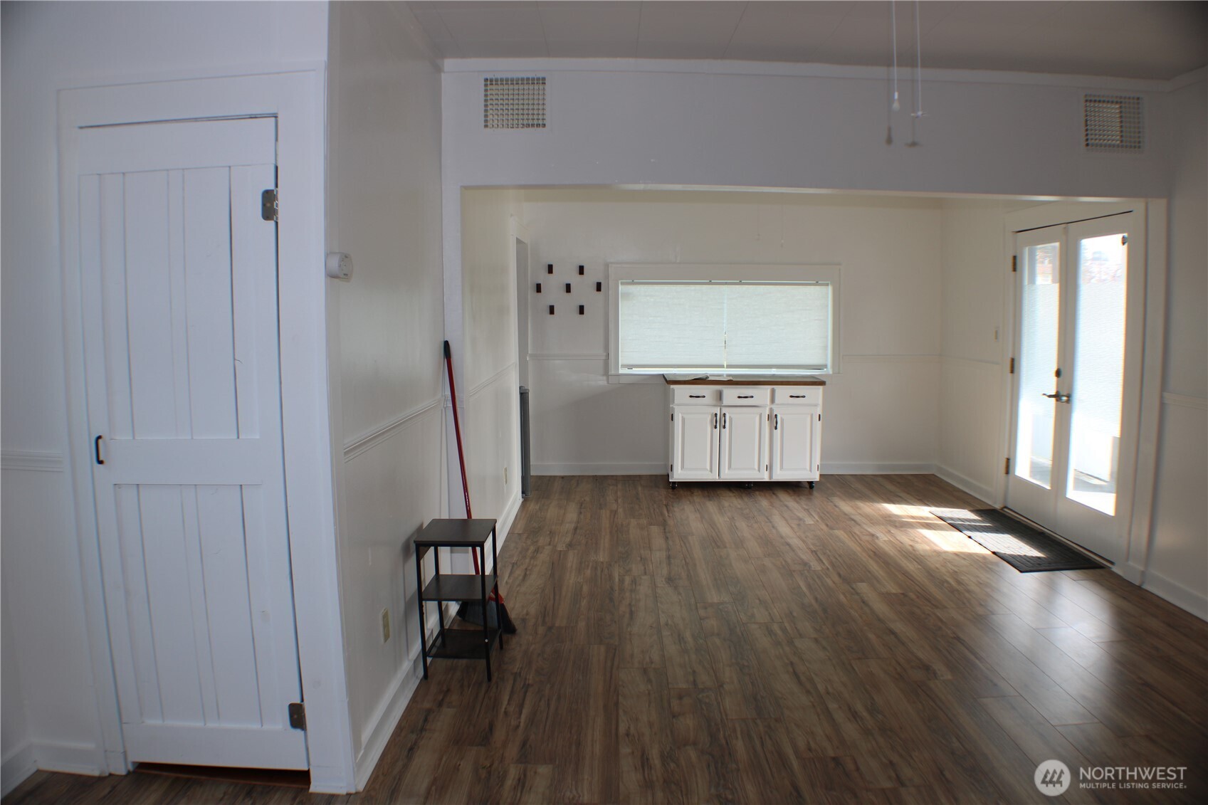 1224 4th Street Cosmopolis, WA 98537 - Photo 16 of 33 a kitchen with a wooden floor and a window