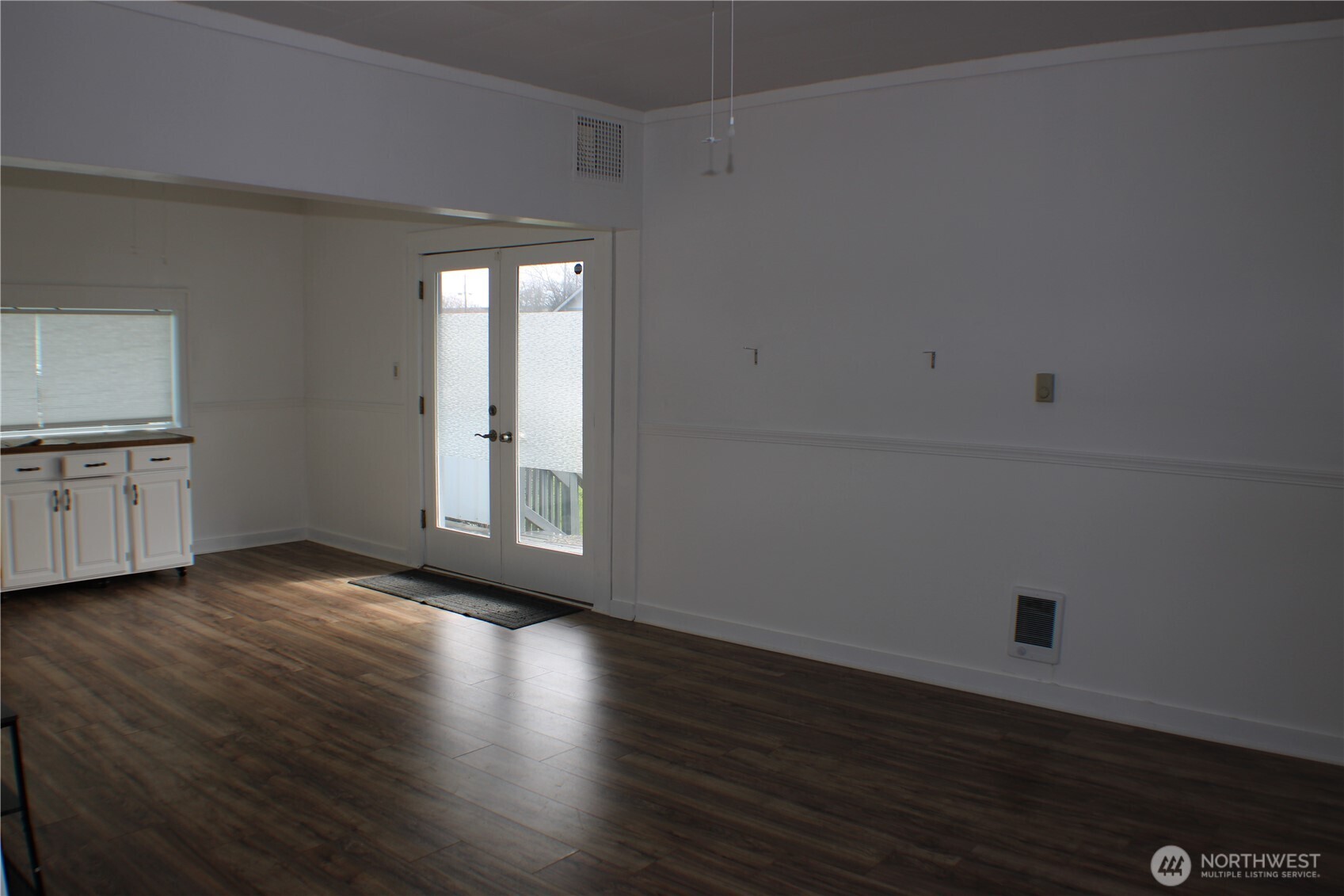 1224 4th Street Cosmopolis, WA 98537 - Photo 4 of 33 an empty room with wooden floor and windows