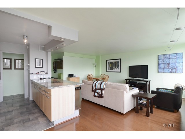 1455 North Sandburg Terrace, Unit 1904 Chicago, IL 60610 - Photo 3 of 7 a living room with furniture and a flat screen tv