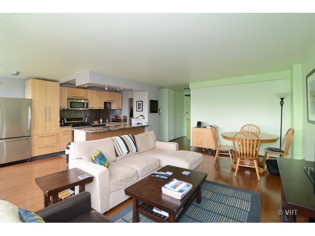 1455 North Sandburg Terrace, Unit 1904 Chicago, IL 60610 - Photo 5 of 7 a living room with furniture and a flat screen tv