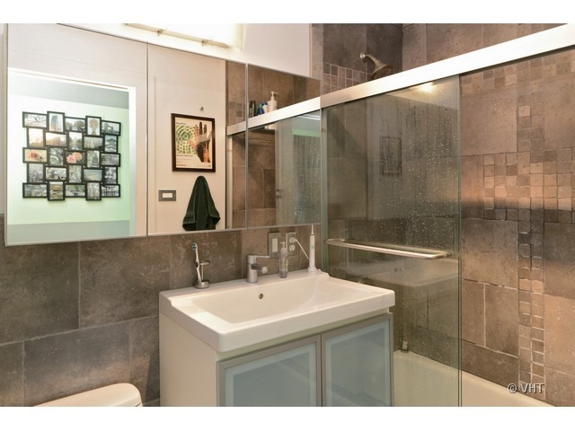 1455 North Sandburg Terrace, Unit 1904 Chicago, IL 60610 - Photo 7 of 7 a bathroom with a sink and a mirror