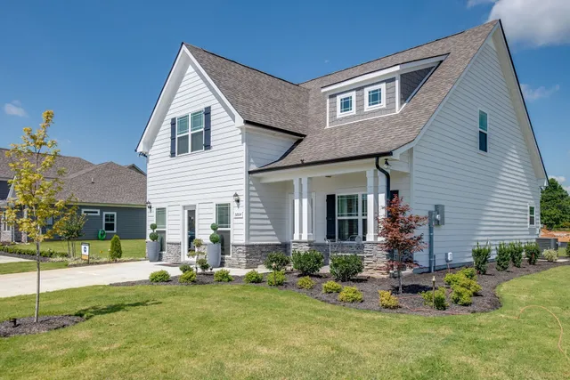 a front view of a house with garden