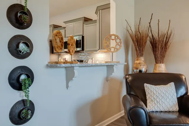 a kitchen with stainless steel appliances granite countertop a sink and a microwave