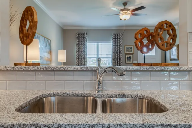 a kitchen with stainless steel appliances granite countertop a stove a sink a microwave a dining table and chairs