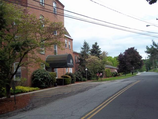 55 Oil Mill Road, Unit 40 Danbury, CT 06810 - Photo 1 of 1 a front view of a house with a yard and street view
