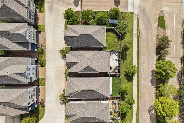 an aerial view of a house with a yard and fountain