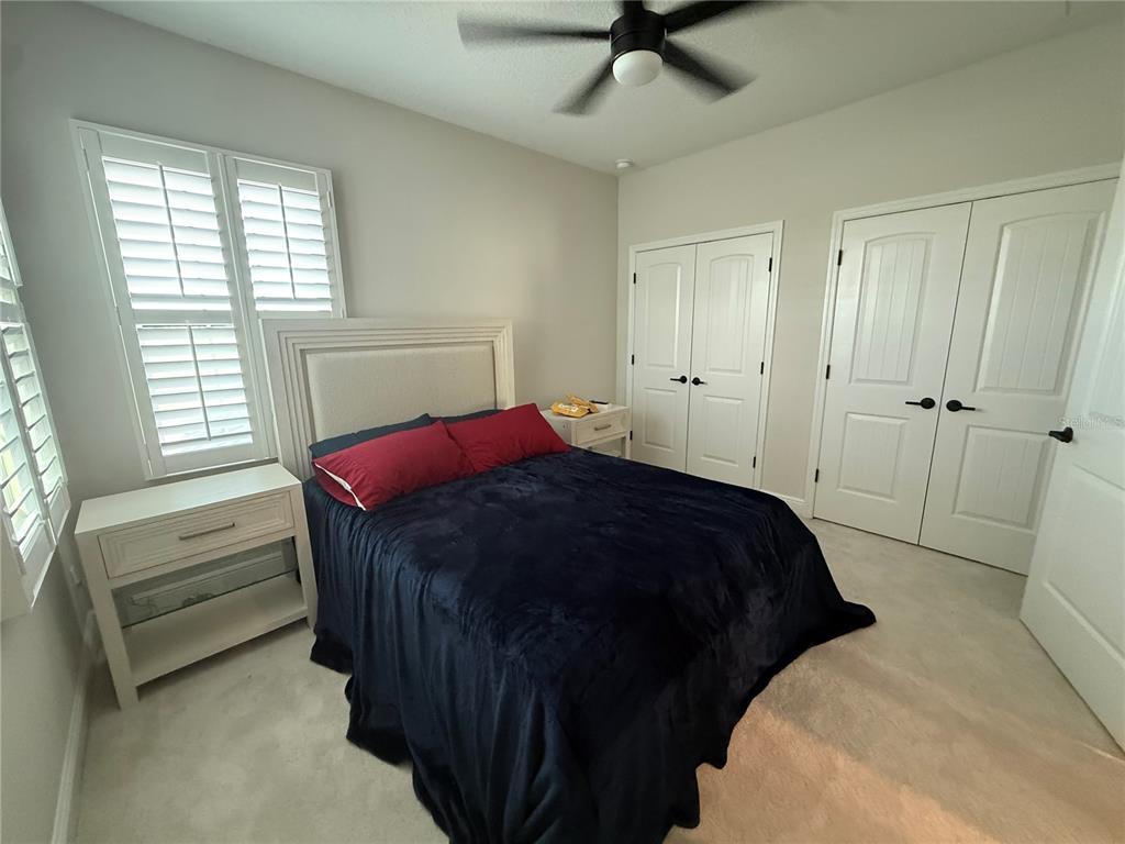10958 Rustic Timber Loop San Antonio, FL 33576 - Photo 23 of 48 a bedroom with a bed and a window