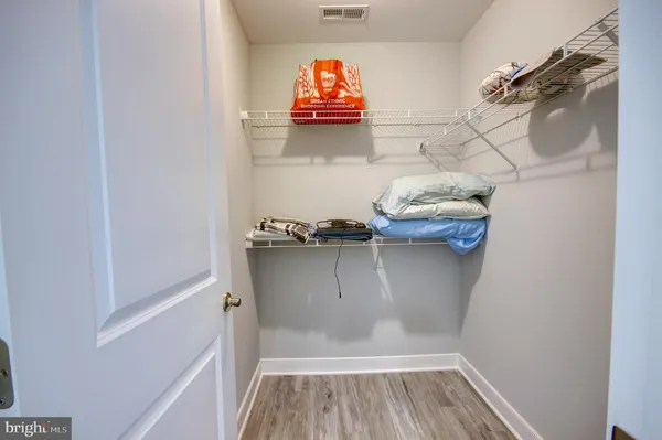 a view of walk in closet with clothes