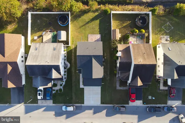 an aerial view of houses with street