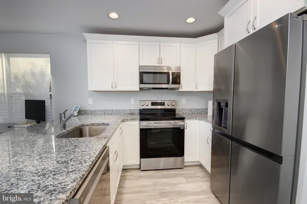 a kitchen with a refrigerator sink and microwave