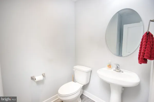 a white toilet sitting next to a bathroom sink