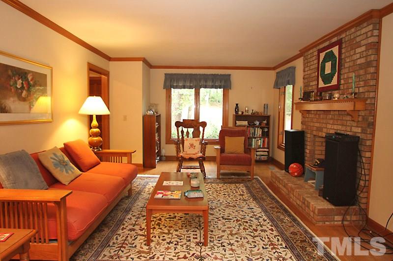 27 Sandstone Ridge Drive Durham, NC 27713 - Photo 2 of 12 a living room with furniture fireplace and flat screen tv