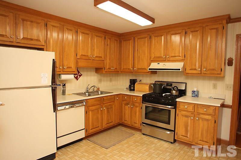 27 Sandstone Ridge Drive Durham, NC 27713 - Photo 6 of 12 a kitchen with stainless steel appliances granite countertop a stove a sink and a refrigerator