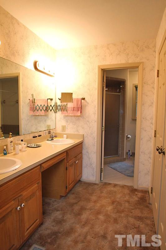 27 Sandstone Ridge Drive Durham, NC 27713 - Photo 8 of 12 a view with a sink and a mirror