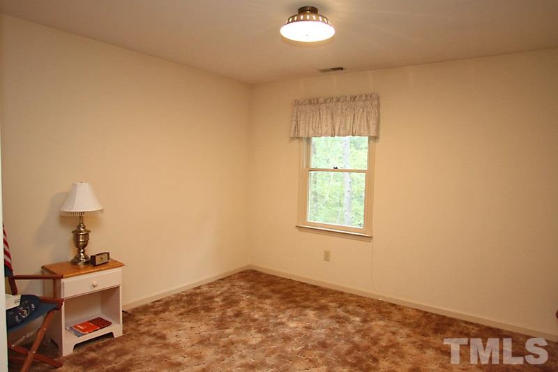 27 Sandstone Ridge Drive Durham, NC 27713 - Photo 10 of 12 an empty room with a window