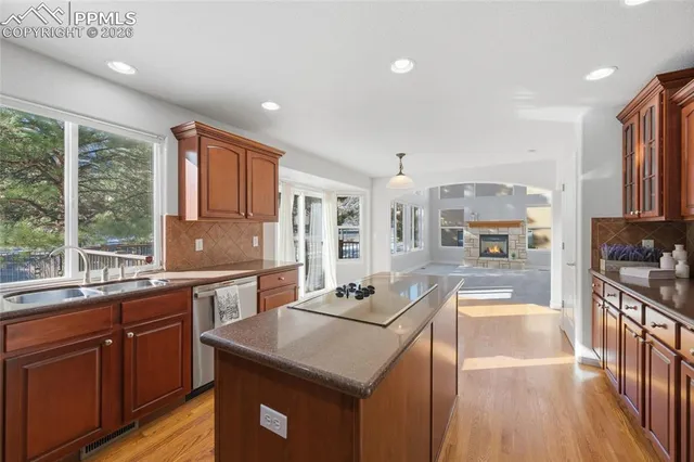 a kitchen with stainless steel appliances granite countertop sink stove top oven and cabinets