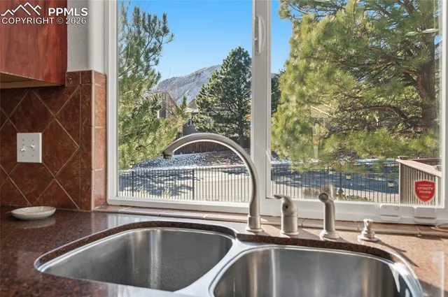 a view of a sink and pool table and chairs