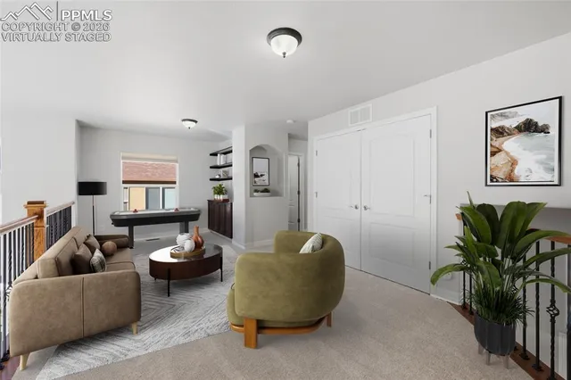 a view of empty room with stairs and wooden floor