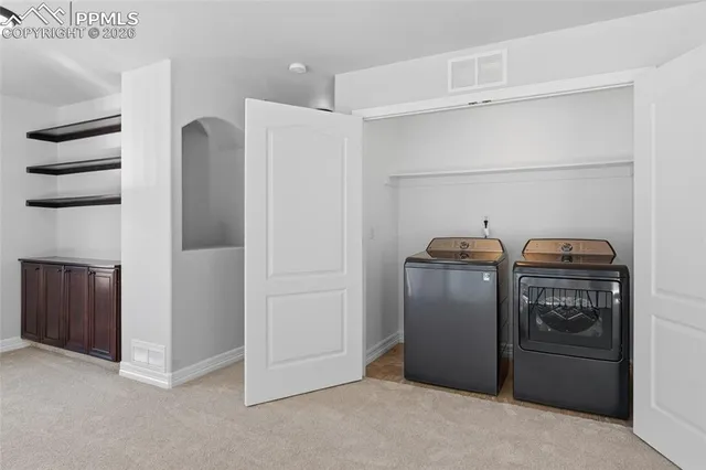 a spacious bedroom with a bed and a flat screen tv