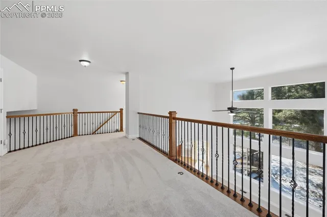 a view of an empty room with kitchen