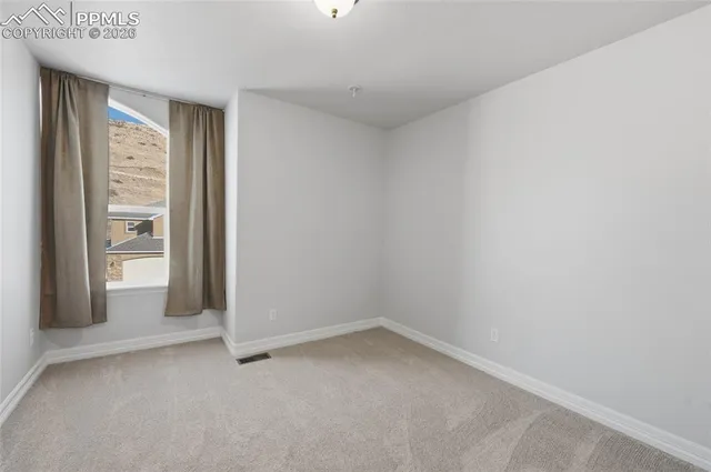 a living room with furniture a rug and a floor to ceiling window
