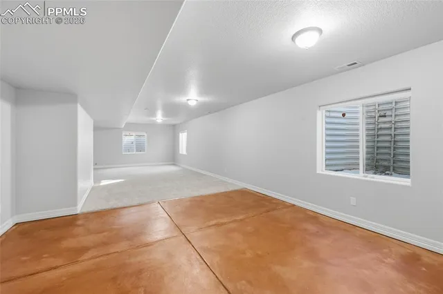 a view of a house with a yard covered in snow
