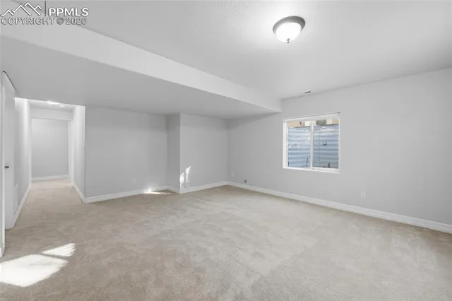 a house with wooden fence and bench in front of it