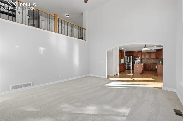 a view of a hallway with wooden floor and a fireplace