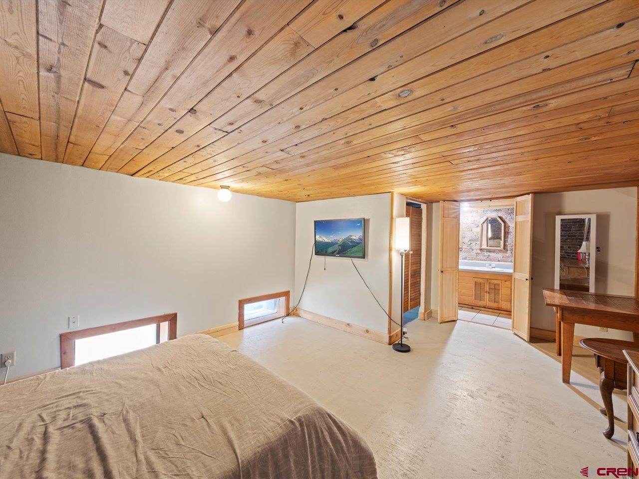 726 Main Street Ouray, CO 81427 - Photo 25 of 41 a bedroom with a bed and wooden floor