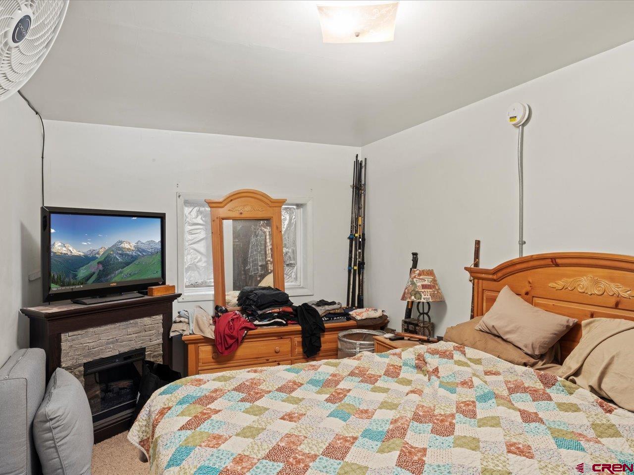 726 Main Street Ouray, CO 81427 - Photo 29 of 41 a bedroom with a bed and a flat screen tv