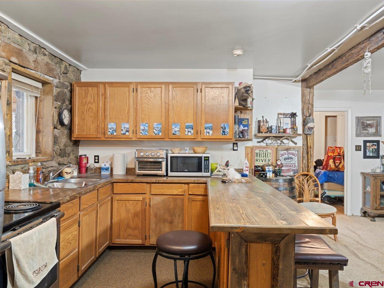 726 Main Street Ouray, CO 81427 - Photo 30 of 41 a kitchen with a table chairs microwave and cabinets