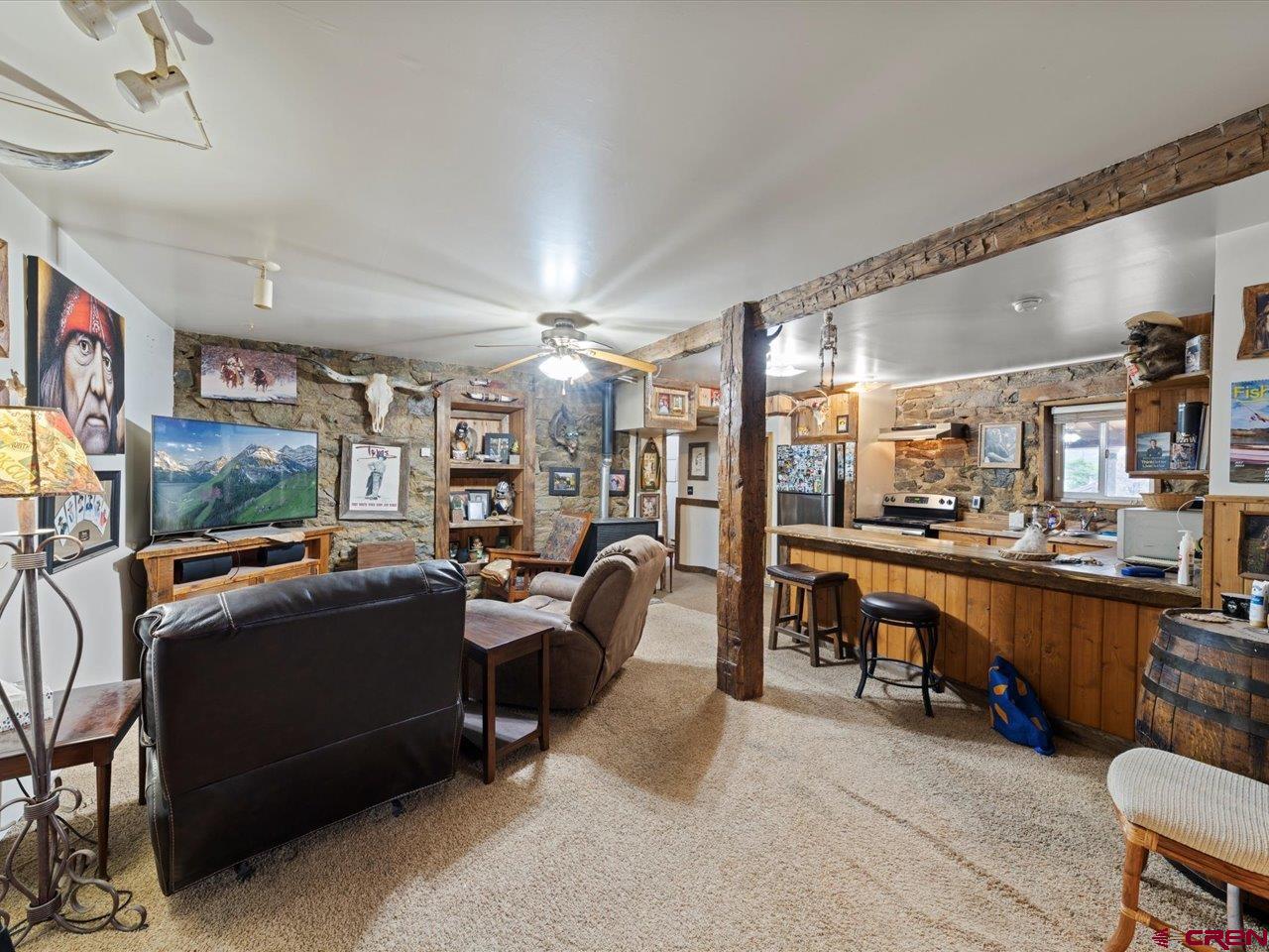 726 Main Street Ouray, CO 81427 - Photo 31 of 41 a living room with furniture a flat screen tv and a large window