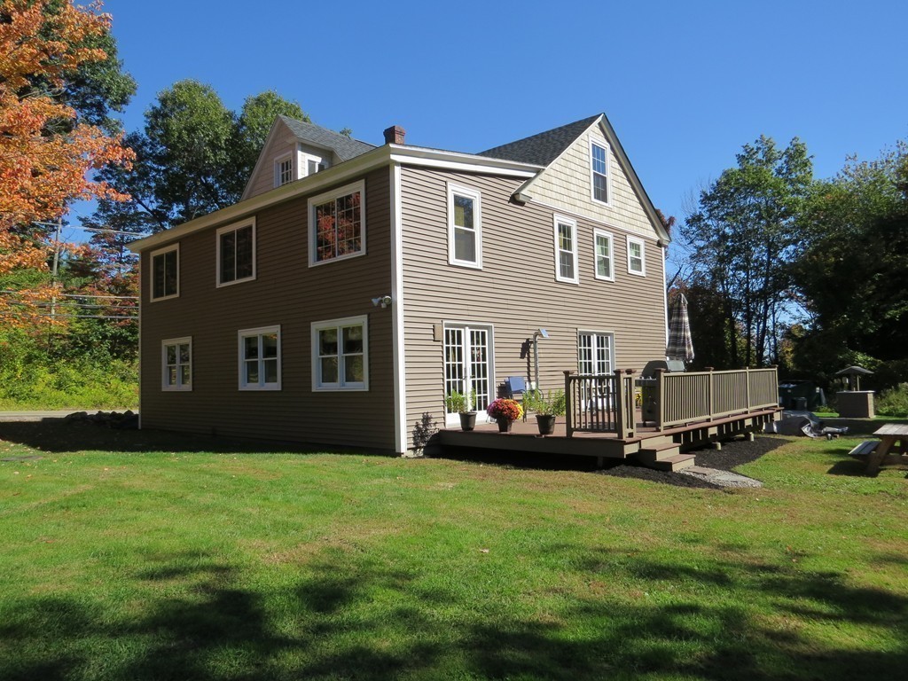 289 Turnpike Road Ashby, MA 01431 - Photo 1 of 13 a front view of a house with a garden