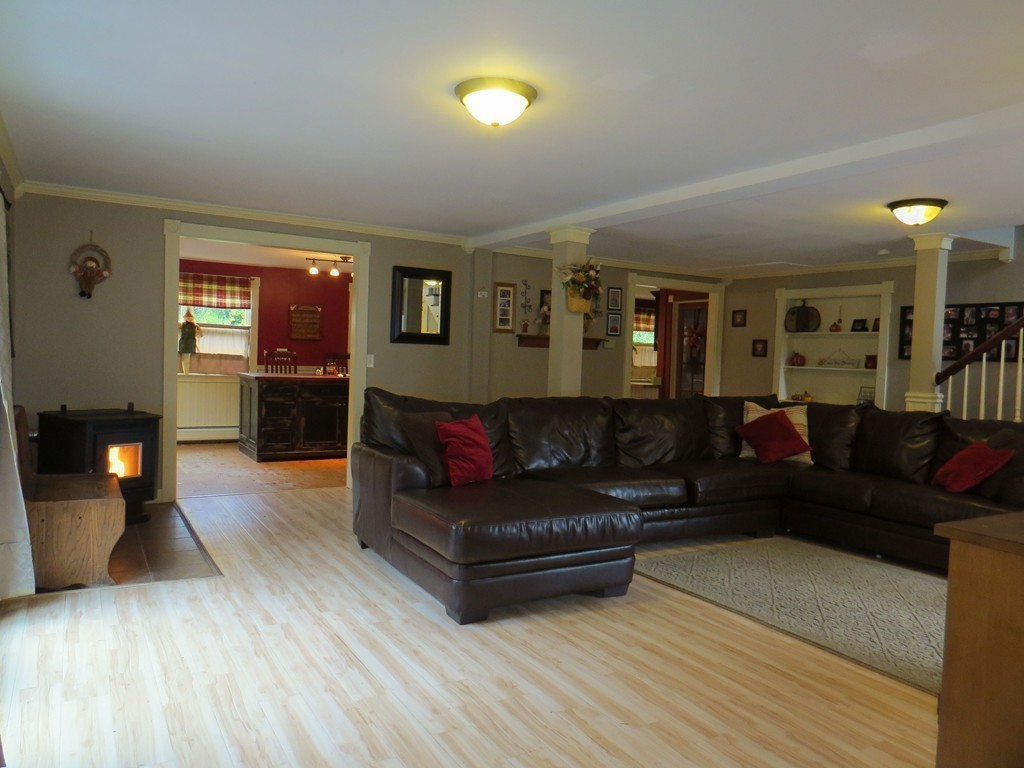 289 Turnpike Road Ashby, MA 01431 - Photo 5 of 13 a living room with furniture and a wooden floor