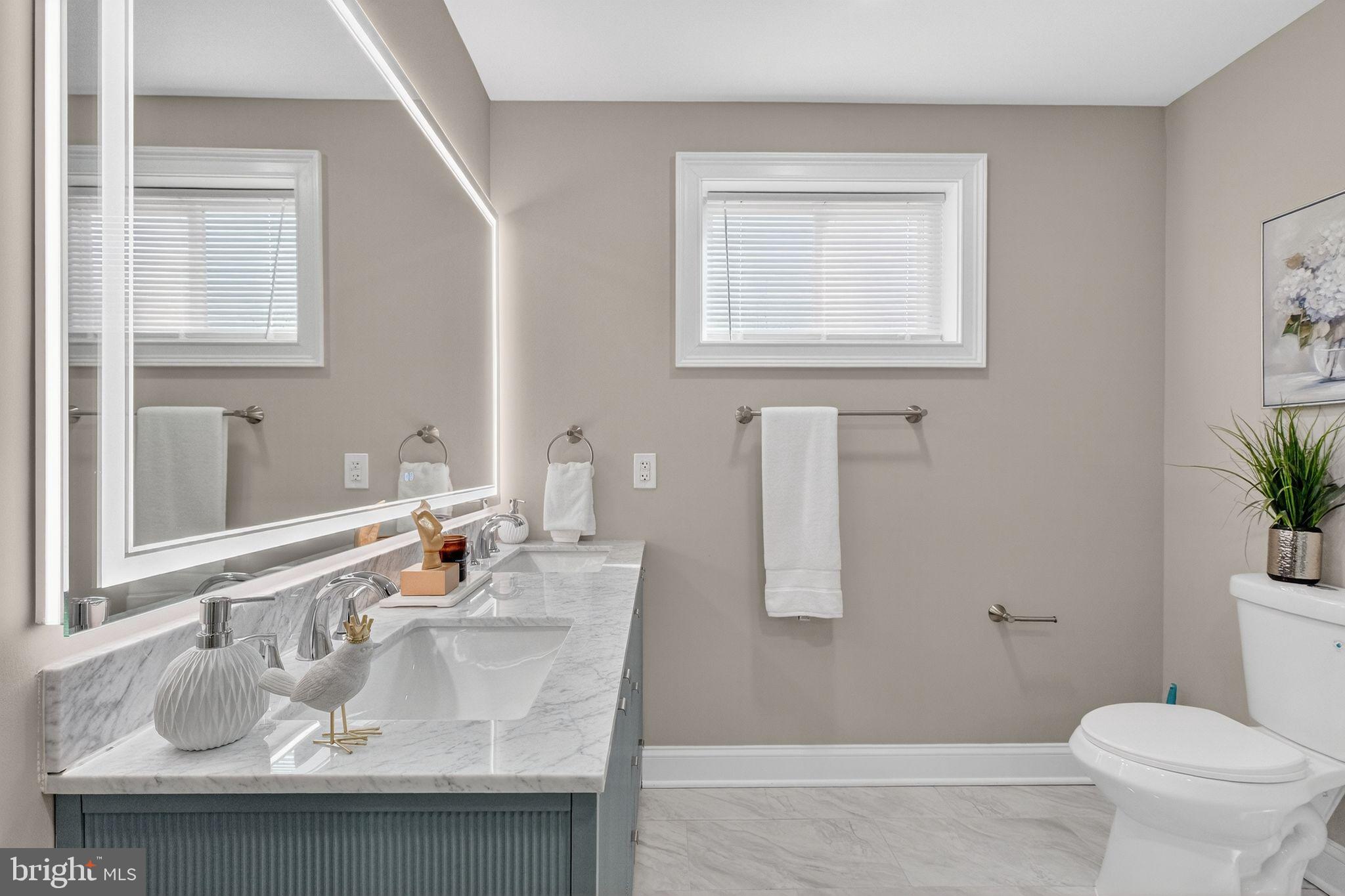 3151 Newton Street Northeast Washington, DC 20018 - Photo 16 of 49 a bathroom with a granite countertop sink a mirror and a toilet