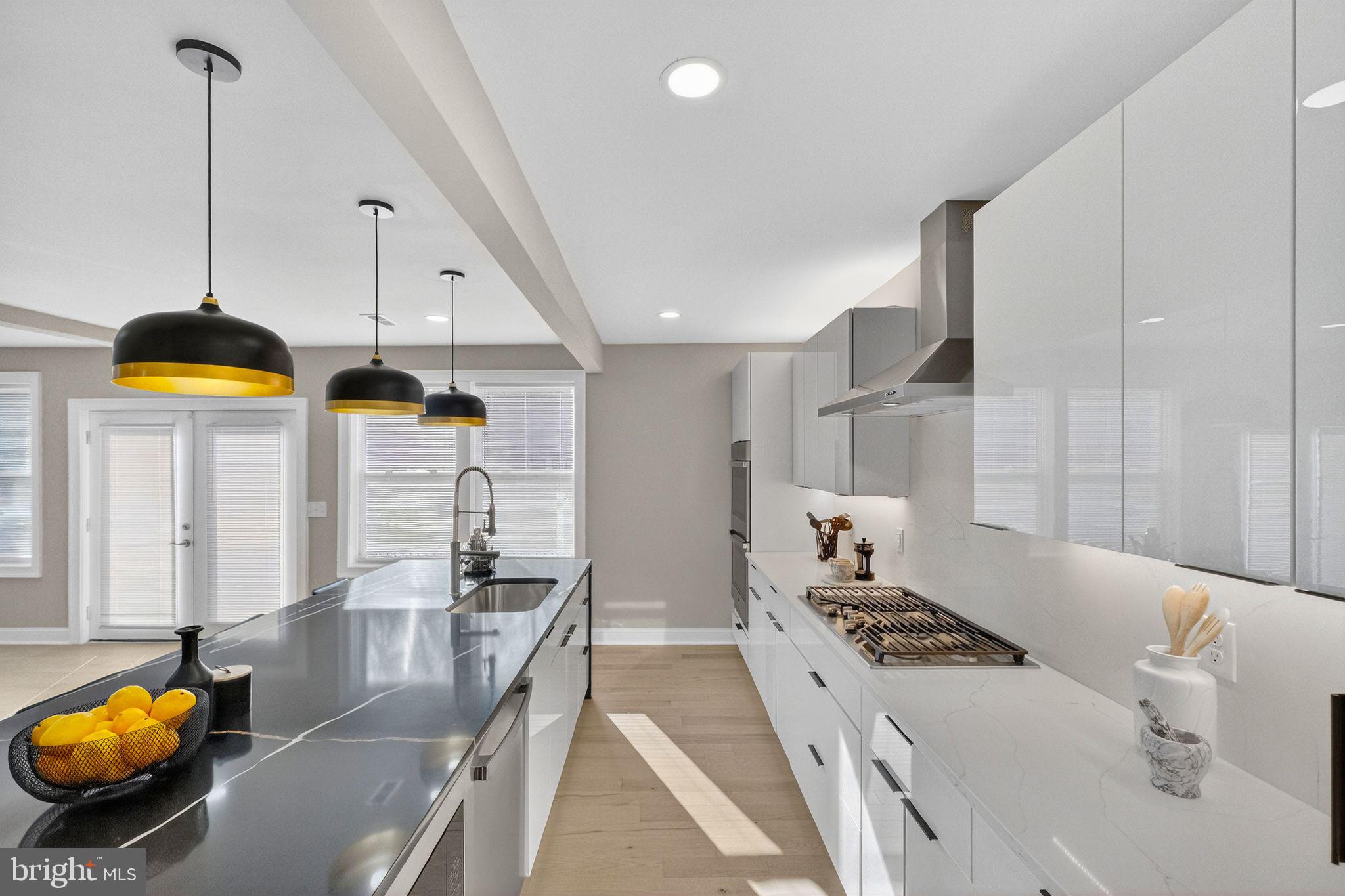 3151 Newton Street Northeast Washington, DC 20018 - Photo 3 of 49 a kitchen with stainless steel appliances kitchen island granite countertop a stove a sink and a white cabinets