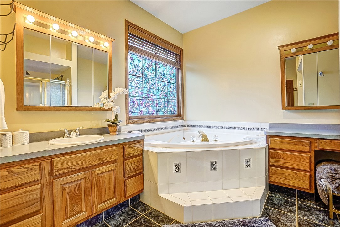 1540 Jasper Road Xenia, OH 45385 - Photo 31 of 91 This bathroom provides a tranquil space with a deep soaking tub and dual vanity.