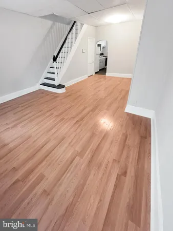 a view of a room with wooden floor and staircase