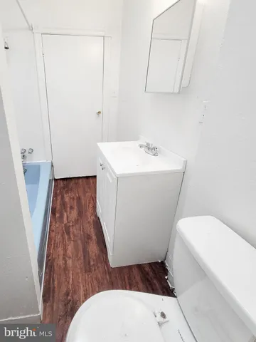 a bathroom with a sink a toilet and mirror