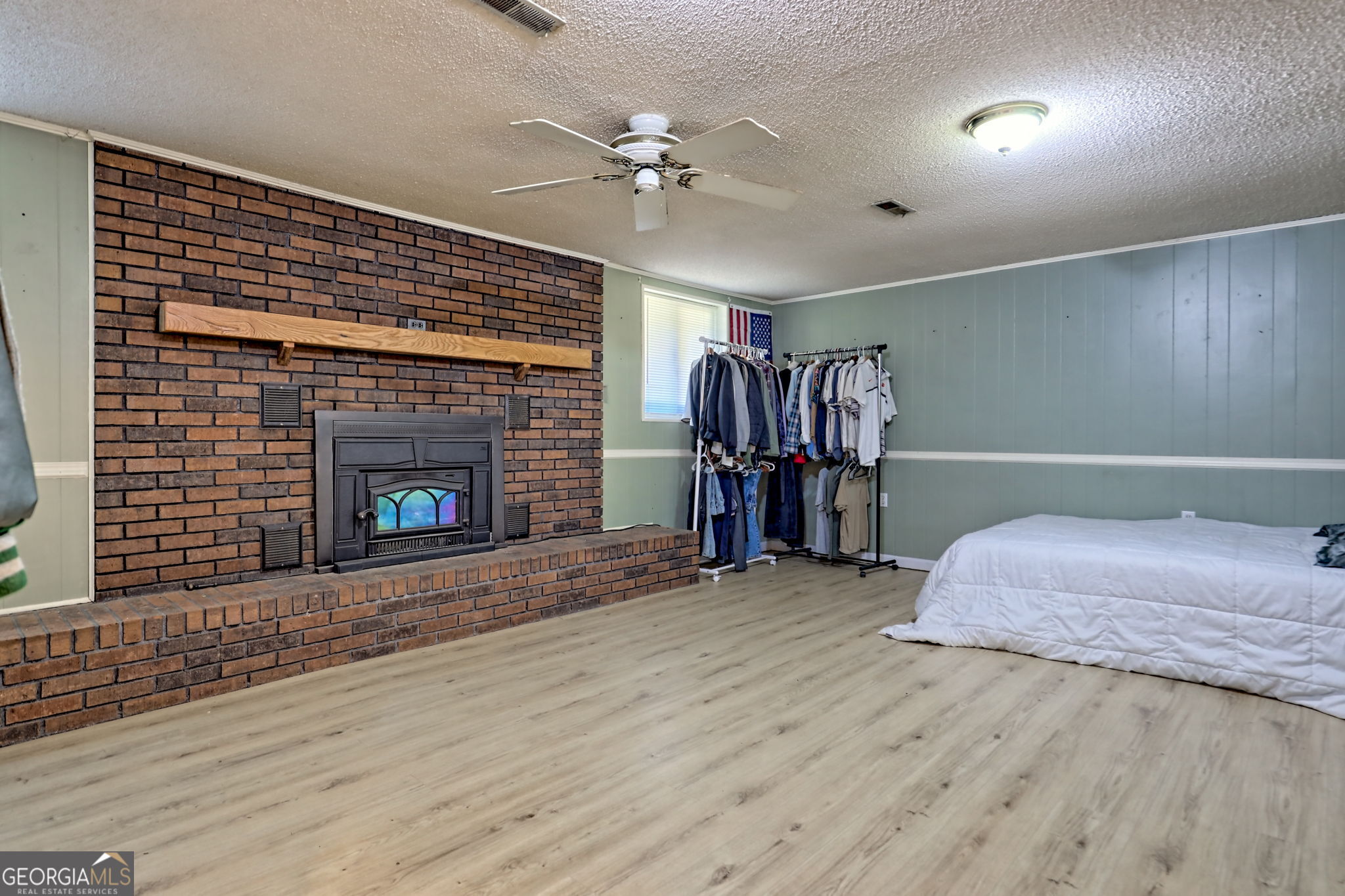 588 Estatohe Circle Toccoa, GA 30577 - Photo 44 of 71 a spacious bedroom with a bed and a fireplace