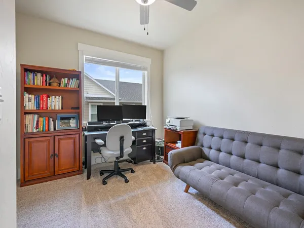 a work room with furniture and a book shelf
