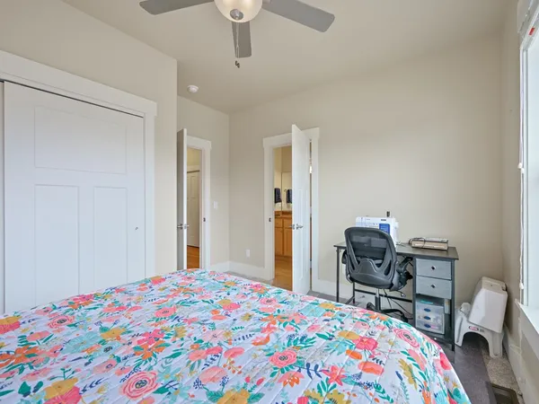 a bedroom with a bed and a desk in it