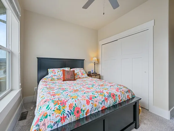 a bedroom with a bed and a small table