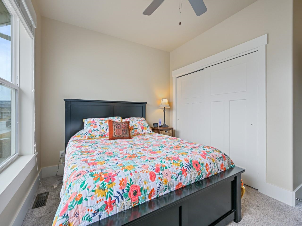 1245 Periwinkle Street Fruita, CO 81521 - Photo 18 of 34 a bedroom with a bed and a small table