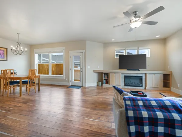 a living room with furniture a fireplace and a flat screen tv