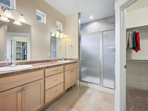 a bathroom with a shower sink and mirror