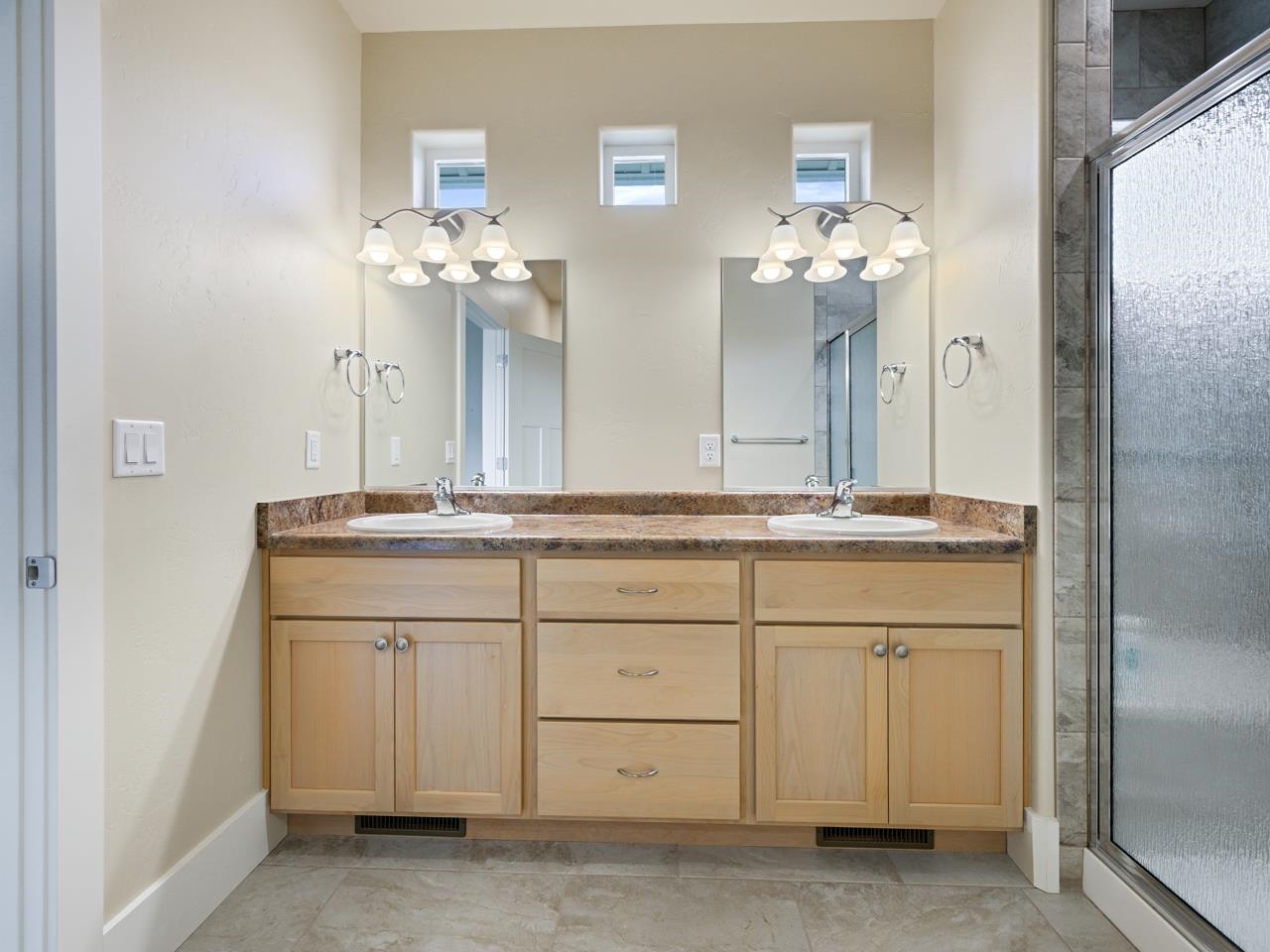 1245 Periwinkle Street Fruita, CO 81521 - Photo 27 of 34 a bathroom with a double vanity sink and a mirror