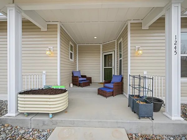 a balcony with furniture and a potted plant