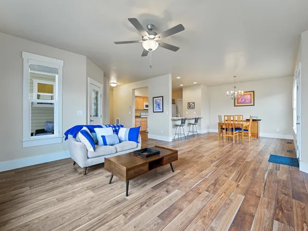 a living room with furniture and wooden floor