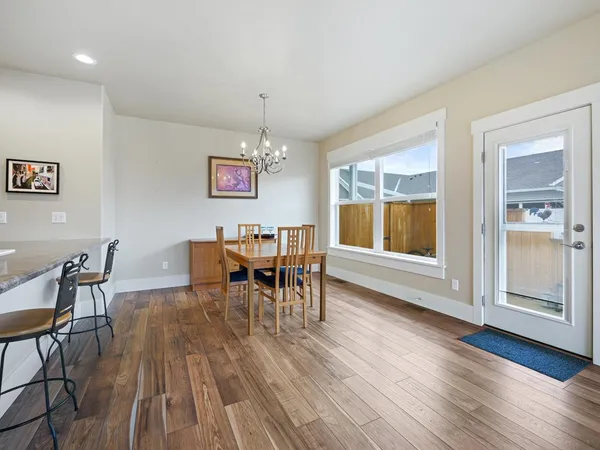 a view of a dining room with furniture and wooden floor